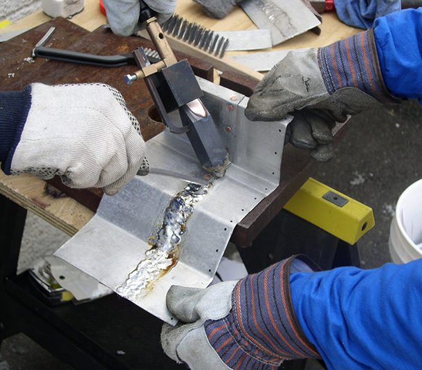 Copper coated flashing being fabricated